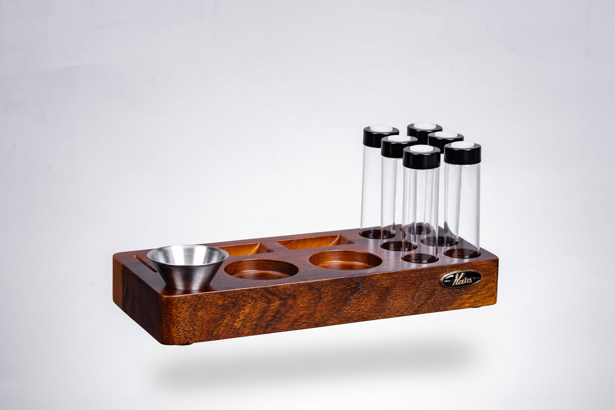 Wooden stand with glass tubes and metal bowls on a gray background