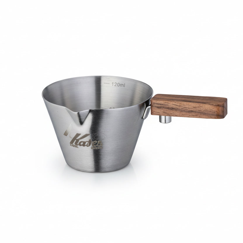 Metal measuring cup with wooden handle on a white background