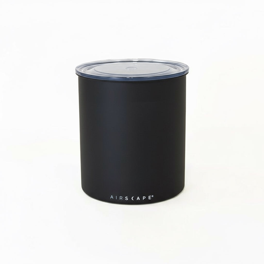 Black cylindrical container with a lid on a white background